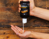 Person pouring Suavecito Beard Wash into hands.